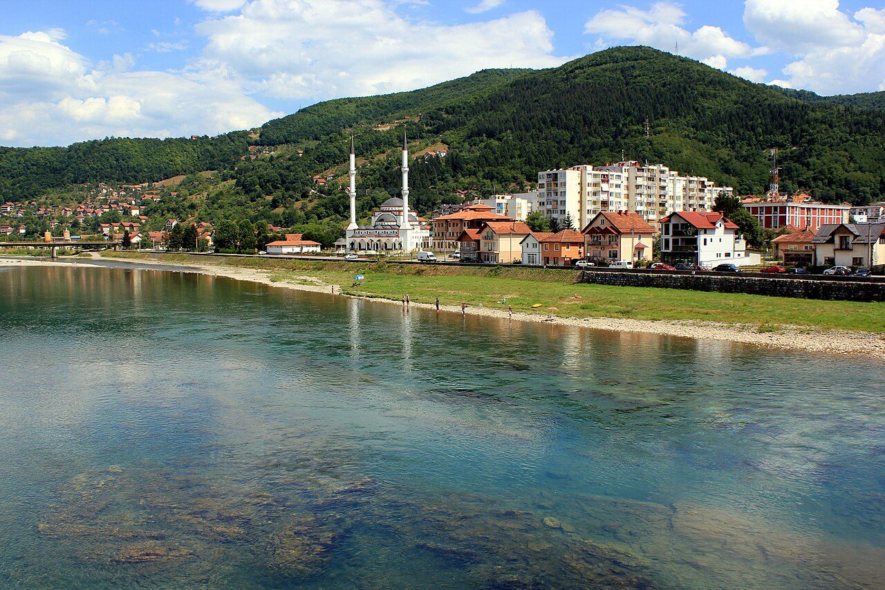 The Drina river flowing through Goražde, with a riverside mosque
